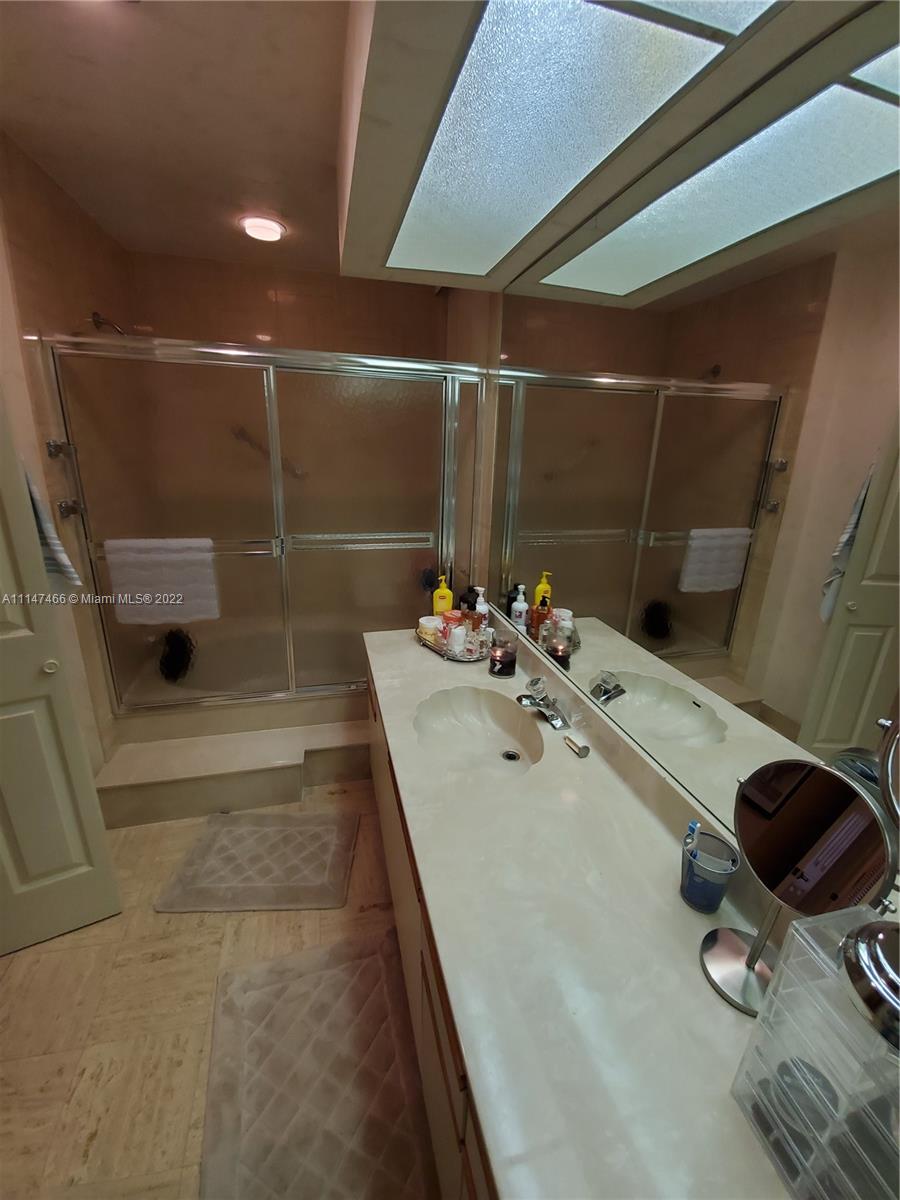 7472 La Paz Boulevard, Unit 104 Boca Raton, FL 33433 - Photo 34 of 44 a bathroom with a sink and a shower