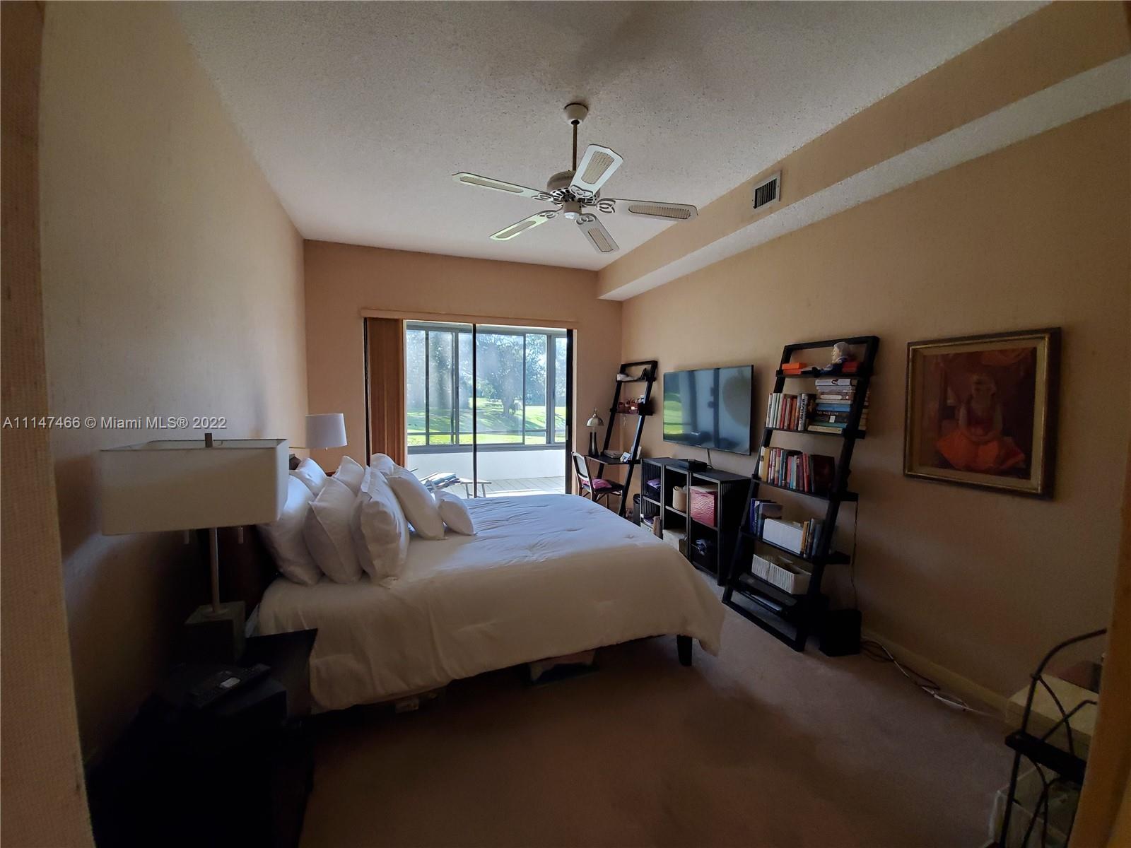 7472 La Paz Boulevard, Unit 104 Boca Raton, FL 33433 - Photo 38 of 44 a bedroom with a bed furniture and a window