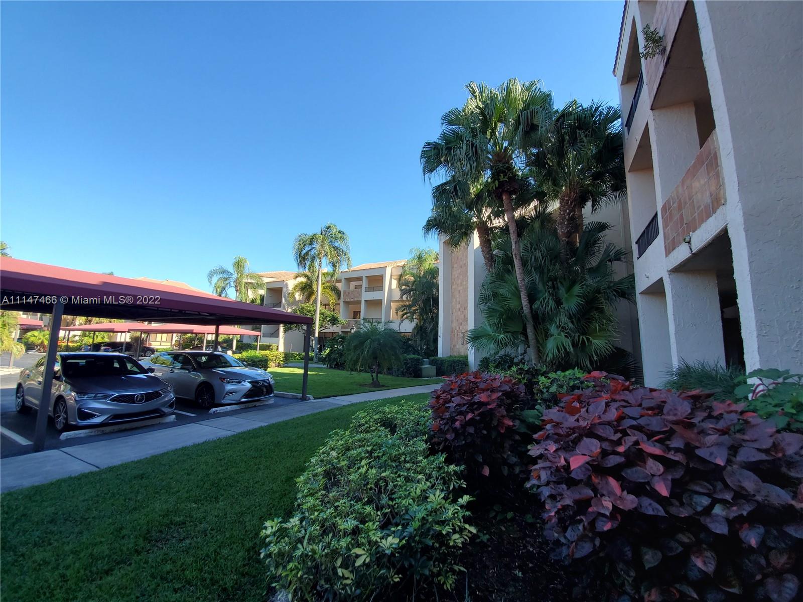7472 La Paz Boulevard, Unit 104 Boca Raton, FL 33433 - Photo 41 of 44 a view of car parked in front of house
