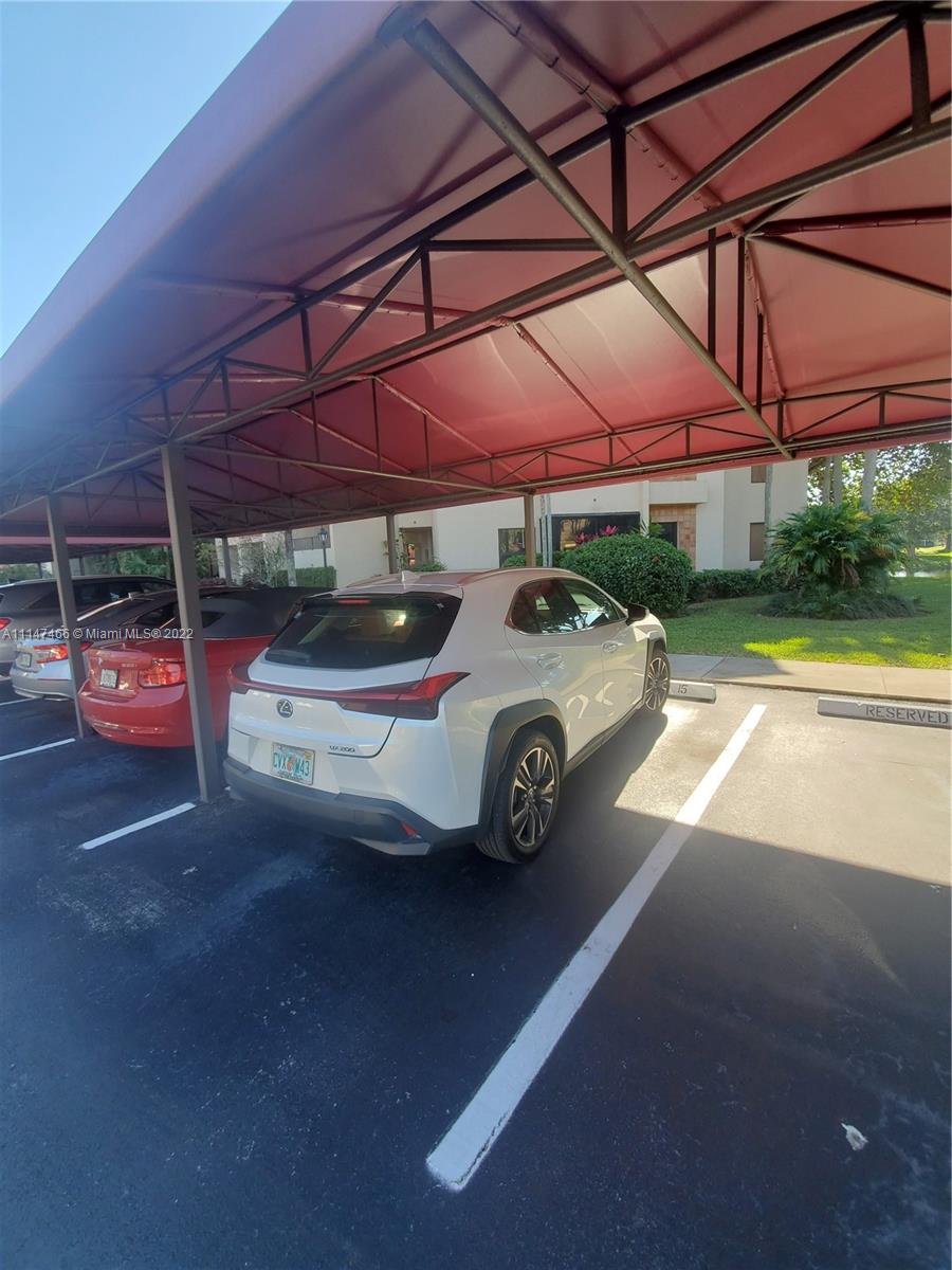 7472 La Paz Boulevard, Unit 104 Boca Raton, FL 33433 - Photo 42 of 44 a car parked in front of a house