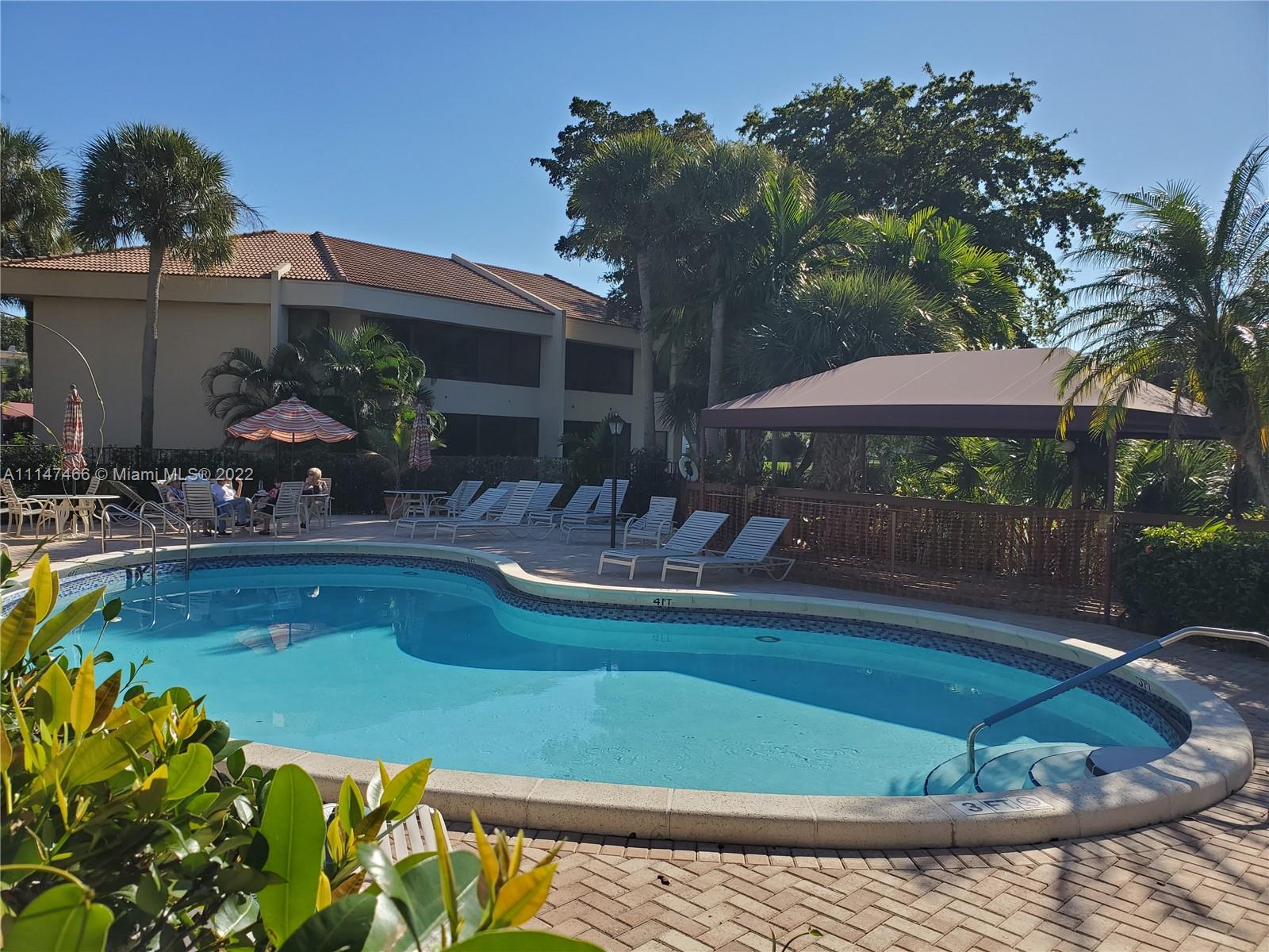 7472 La Paz Boulevard, Unit 104 Boca Raton, FL 33433 - Photo 44 of 44 a view of a swimming pool with a patio