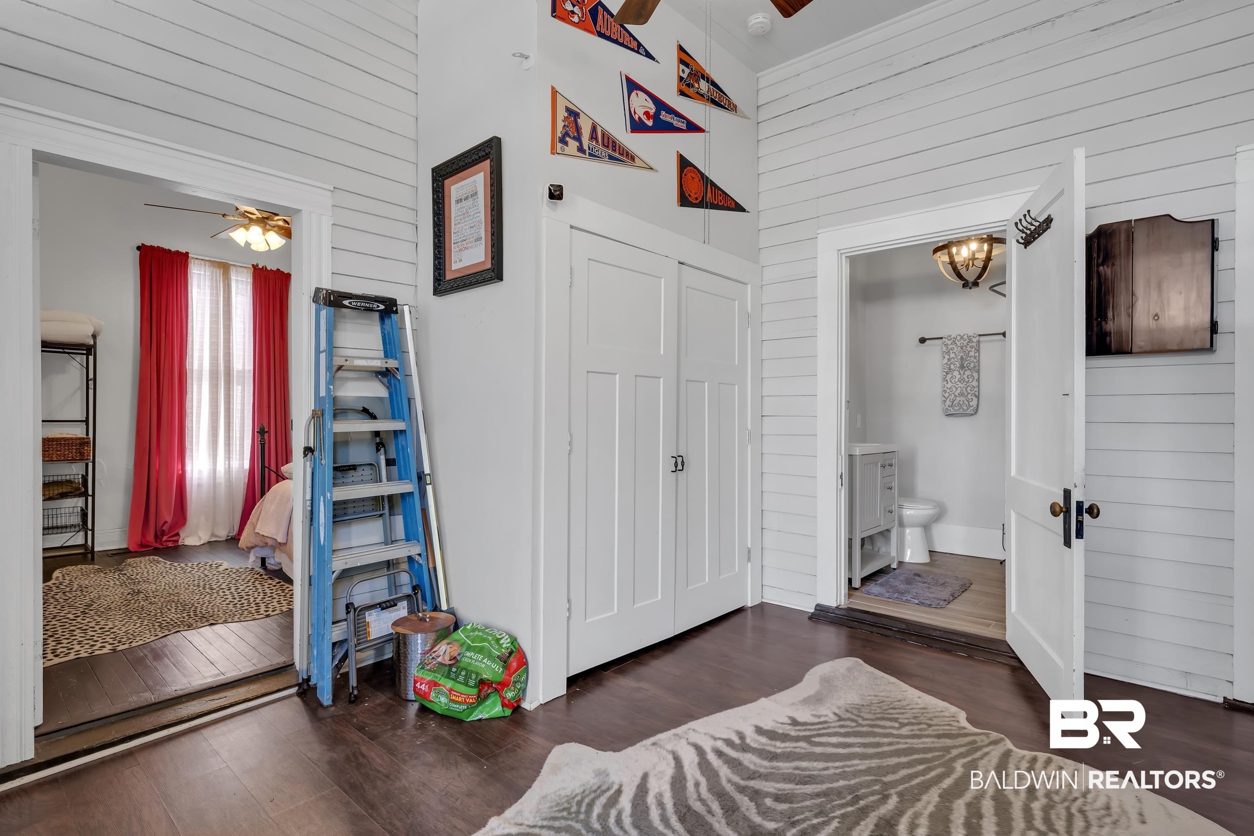 1322 Dauphin Street Mobile, AL 36604 - Photo 15 of 21 Bedroom with wood walls, dark wood-style floors, a high ceiling, and connected bathroom