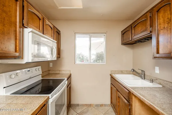 a kitchen with a sink stove and refrigerator