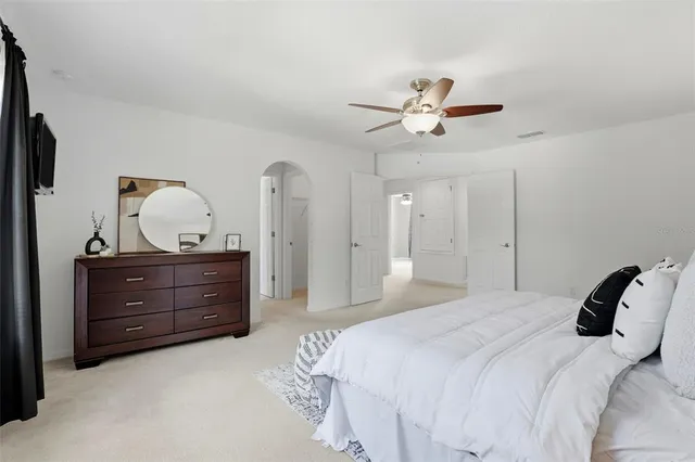 a bathroom with a sink a large mirror and a light fixture