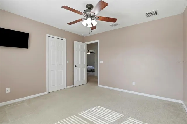 a view of an empty room with a closet