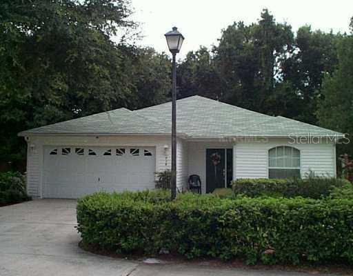 718 Rockingham Road Lakeland, FL 33809 - Photo 1 of 1 a front view of a house with a yard and garage