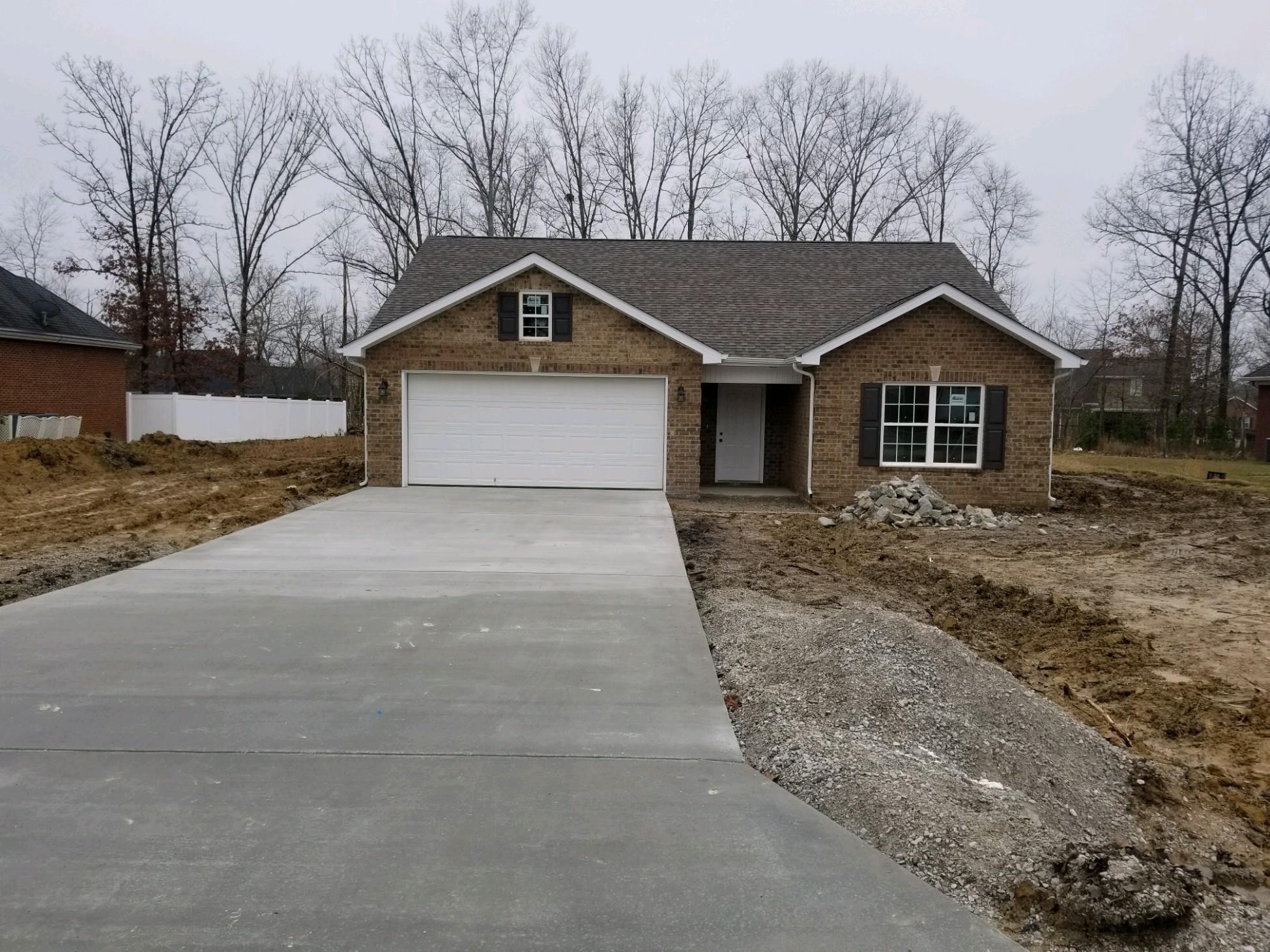 320 Oak Hollow Road Manchester, TN 37355 - Photo 1 of 9 a front view of a house with a yard and garage