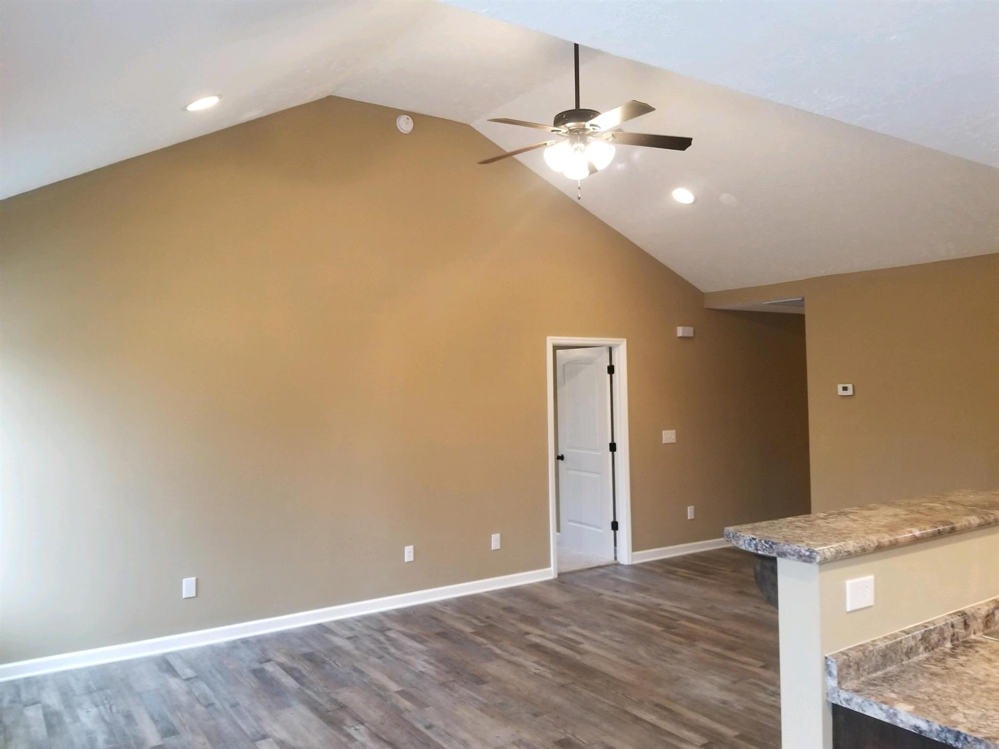 320 Oak Hollow Road Manchester, TN 37355 - Photo 2 of 9 wooden floor in an empty room with a window