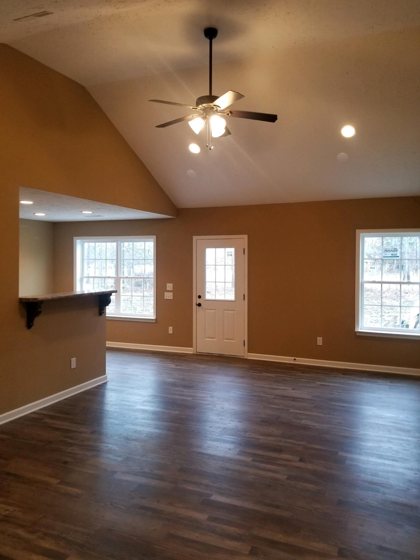 320 Oak Hollow Road Manchester, TN 37355 - Photo 3 of 9 an empty room with wooden floor and windows