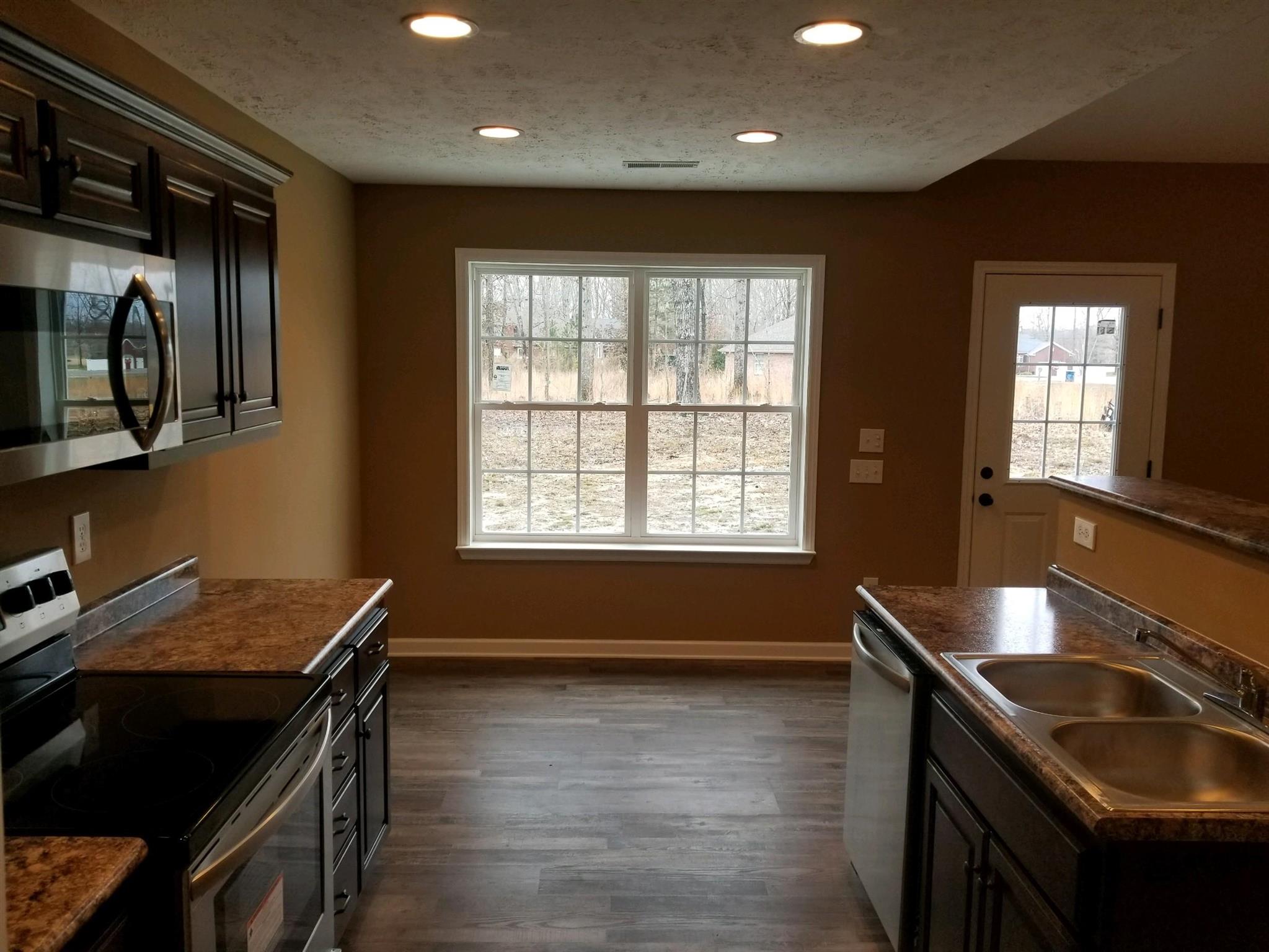 320 Oak Hollow Road Manchester, TN 37355 - Photo 5 of 9 a kitchen with a sink stove and cabinets