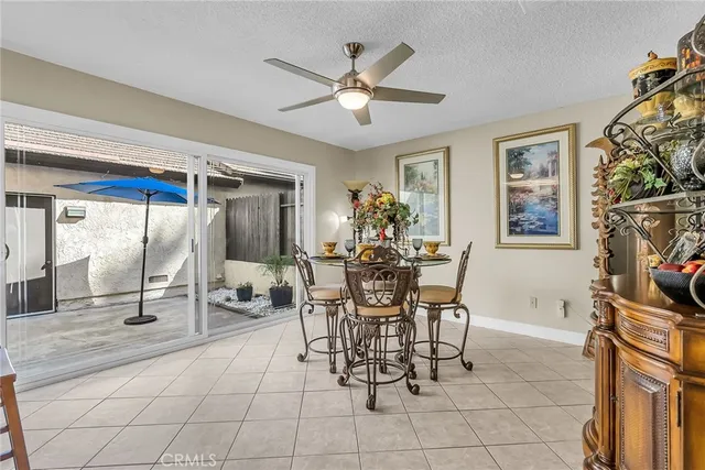 a dining room with chandelier and glass door