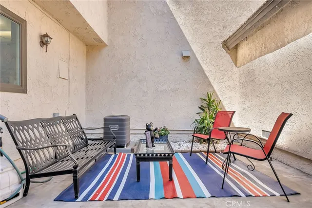 a view of a patio with a table and chairs