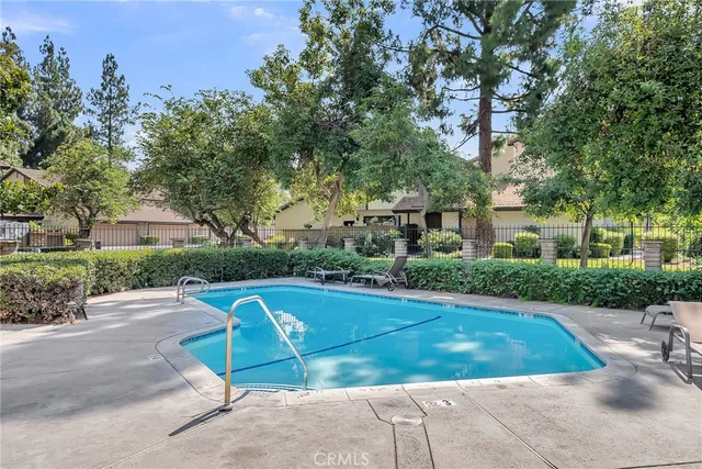 a view of a house with pool and chairs