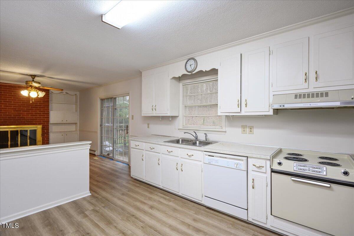 155 Barclay Road Durham, NC 27712 - Photo 18 of 23 a kitchen with a sink a stove and cabinets