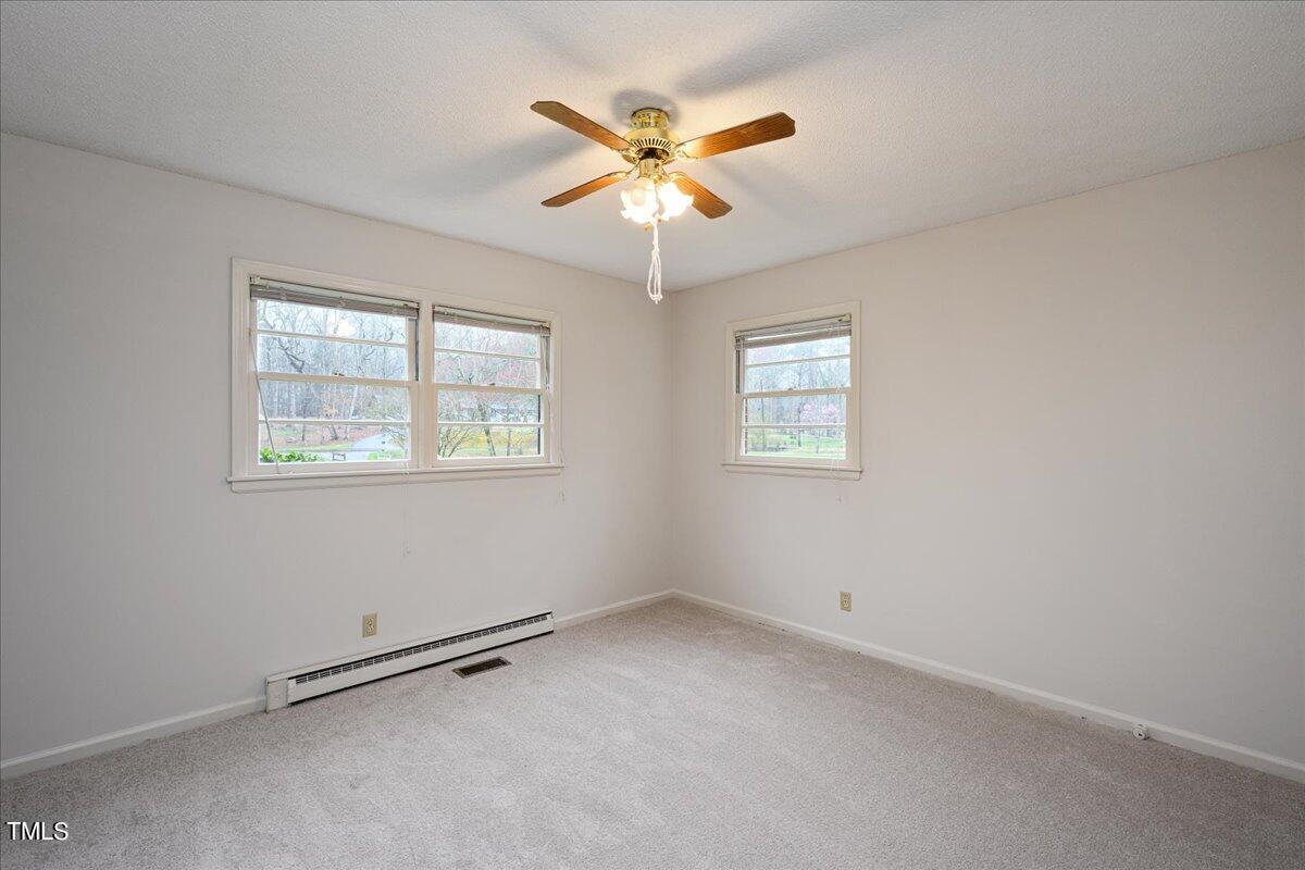 155 Barclay Road Durham, NC 27712 - Photo 9 of 23 an view of an empty room with window and ceiling fan