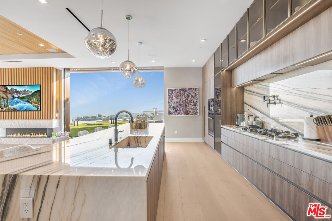 1033 Somera Road Los Angeles, CA 90077 - Photo 18 of 72 a view of a kitchen with kitchen island and stainless steel appliances