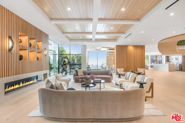 a living room with furniture and large windows