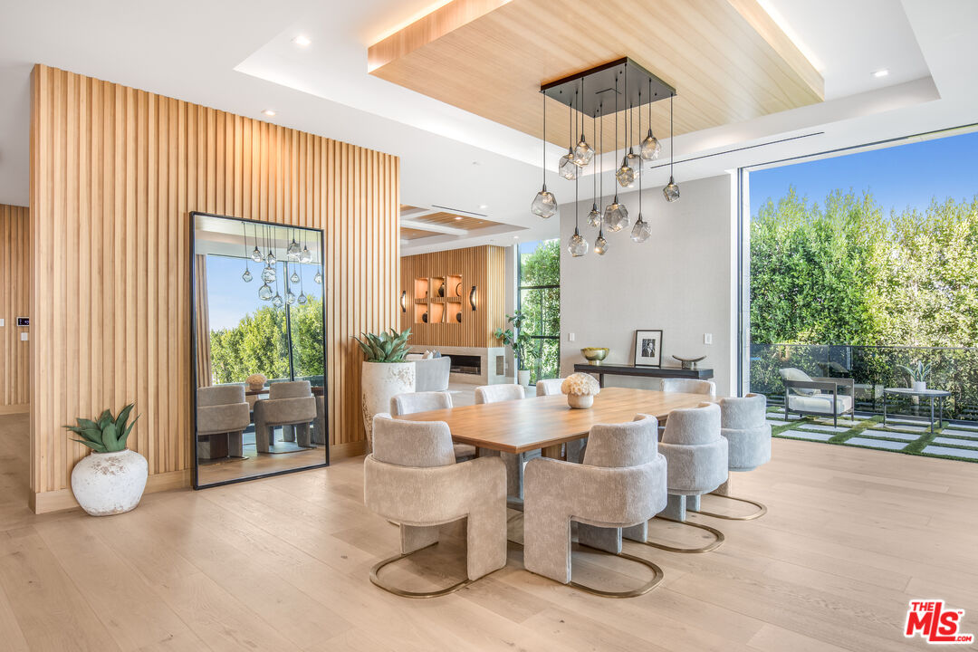 1033 Somera Road Los Angeles, CA 90077 - Photo 24 of 72 a view of a dining room with furniture wooden floor and chandelier