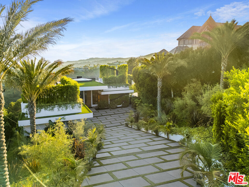 1033 Somera Road Los Angeles, CA 90077 - Photo 3 of 72 a view of a balcony with floor to ceiling windows and yard