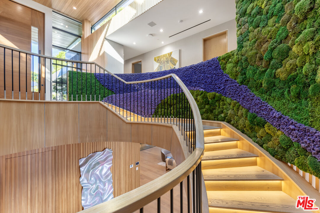 1033 Somera Road Los Angeles, CA 90077 - Photo 32 of 72 a view of stairs and flowers with wooden floor