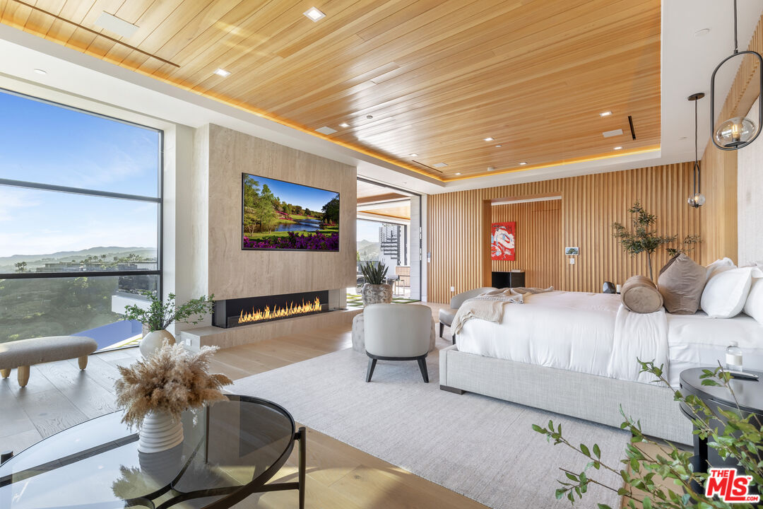1033 Somera Road Los Angeles, CA 90077 - Photo 40 of 72 a bedroom with a bed and large windows