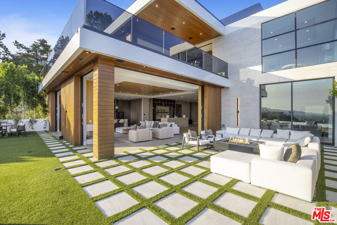 1033 Somera Road Los Angeles, CA 90077 - Photo 4 of 72 a view of a patio with couches table and chairs and potted plants