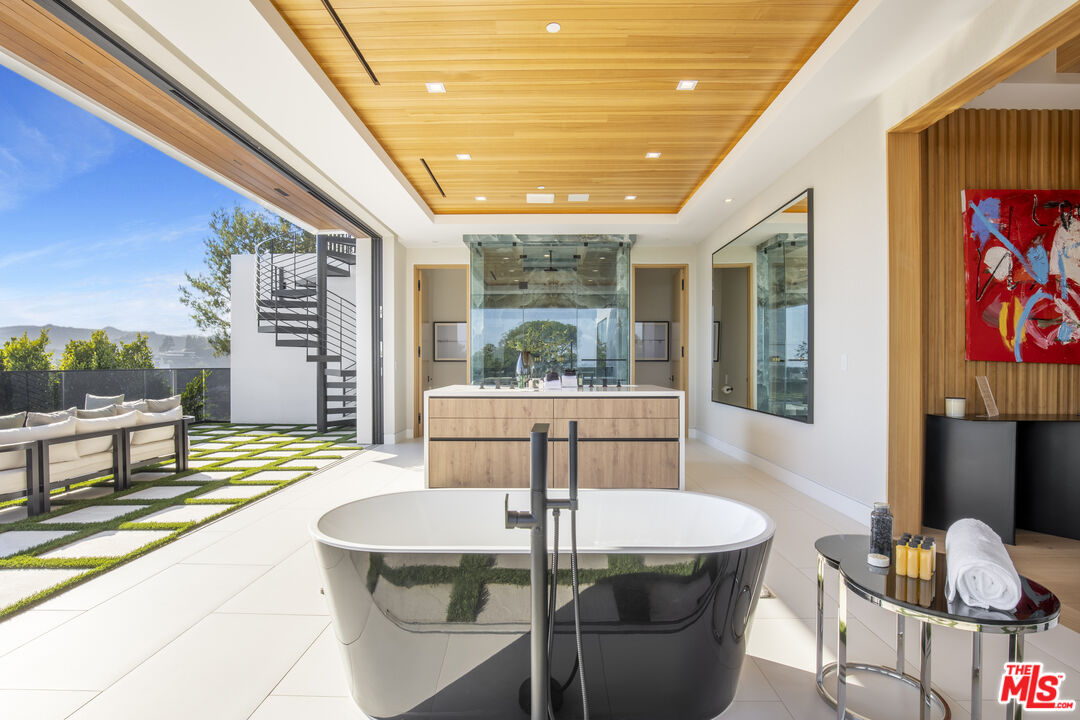 1033 Somera Road Los Angeles, CA 90077 - Photo 41 of 72 a dining room with furniture and a floor to ceiling window