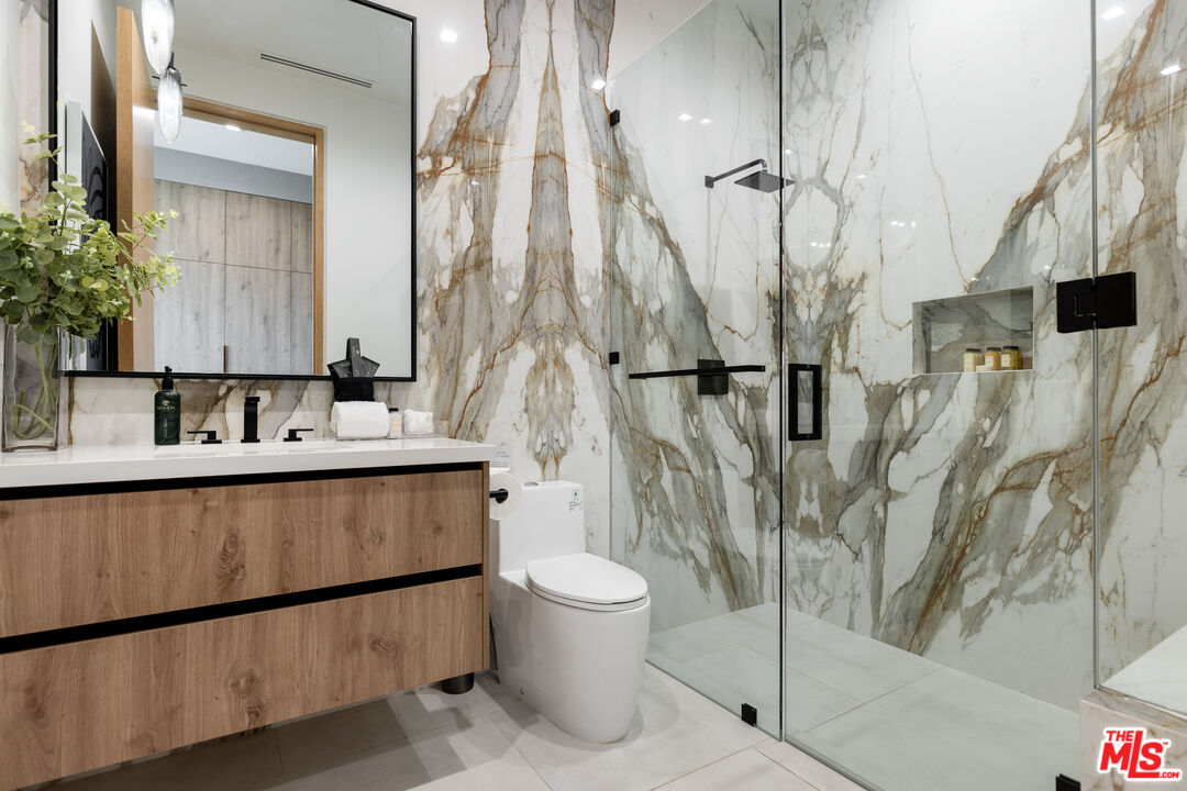 1033 Somera Road Los Angeles, CA 90077 - Photo 50 of 72 a bathroom with a sink a toilet and shower