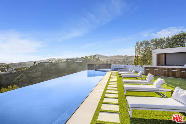 a view of swimming pool with a patio