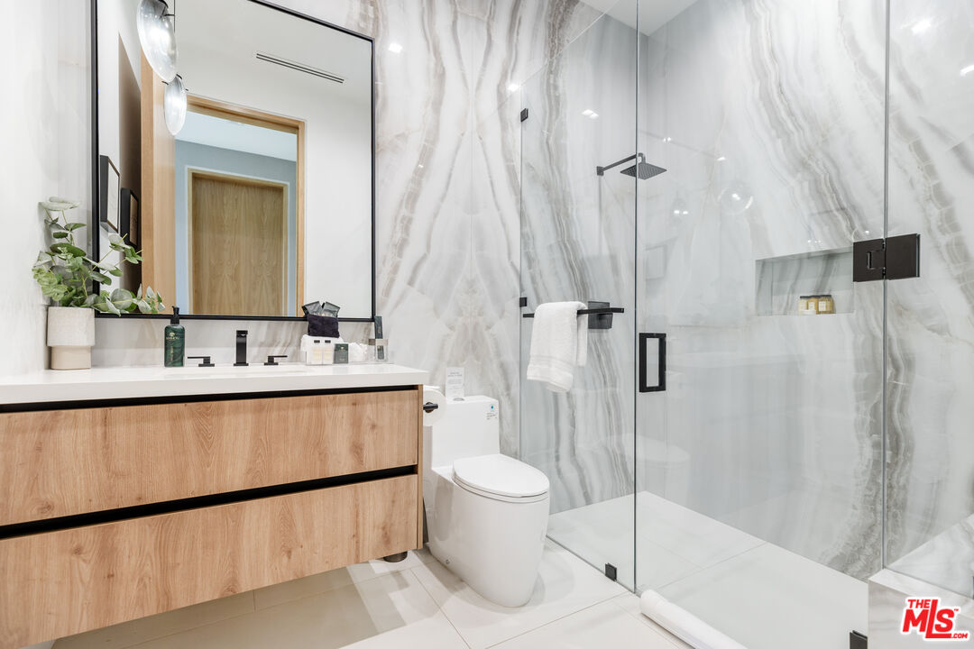 1033 Somera Road Los Angeles, CA 90077 - Photo 53 of 72 a bathroom with a sink a toilet and shower