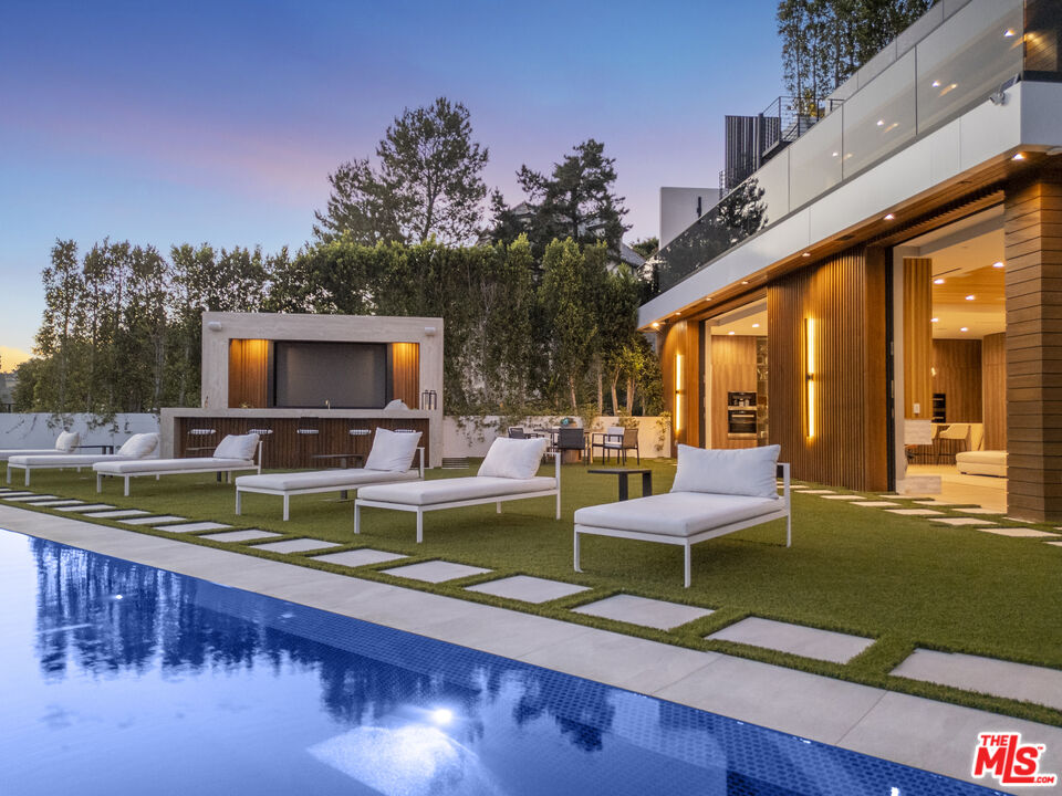 1033 Somera Road Los Angeles, CA 90077 - Photo 66 of 72 a view of swimming pool with outdoor seating and a garden