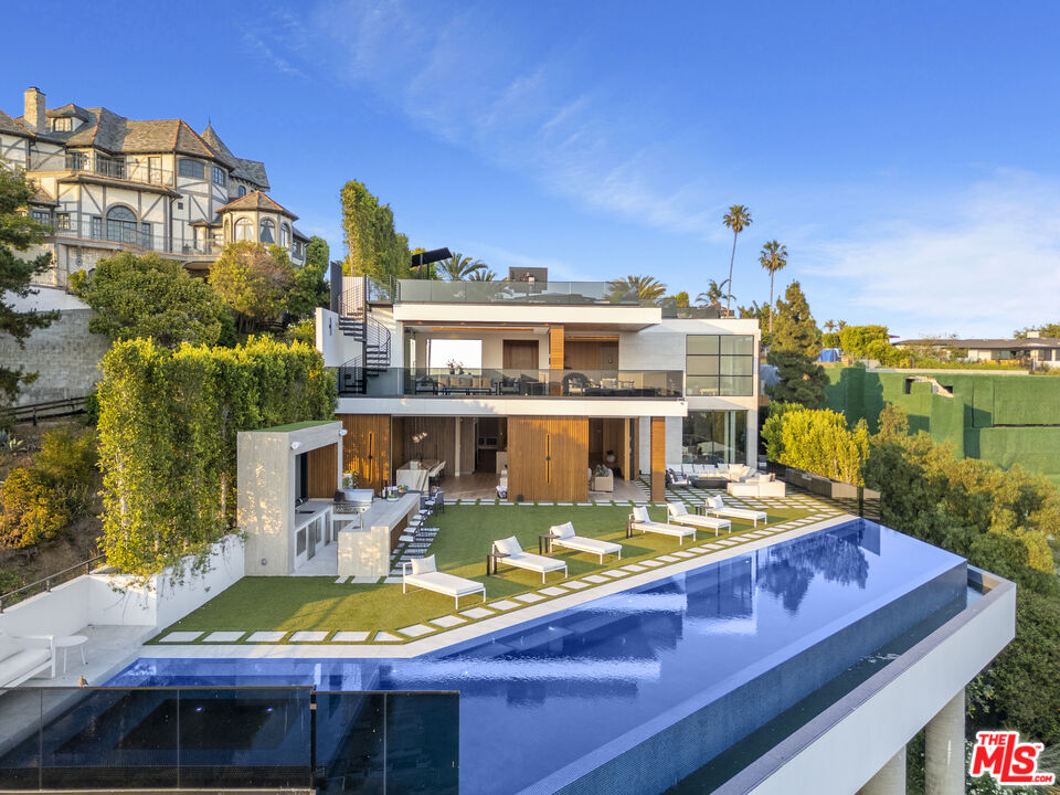 1033 Somera Road Los Angeles, CA 90077 - Photo 70 of 72 a view of a swimming pool with a patio