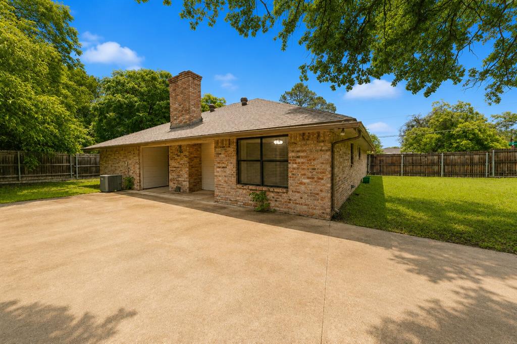 1001 Rosebud Drive Azle, TX 76020 - Photo 36 of 36 Brick exterior with a prominent chimney, a two-car garage, and a concrete driveway