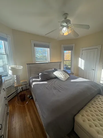 a bed sitting in a bedroom and chandelier