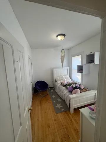 a bedroom with furniture and a window