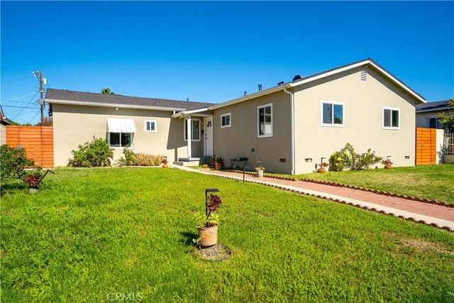 a front view of house with yard and outdoor seating