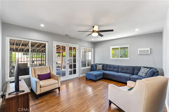 a living room with furniture and wooden floor