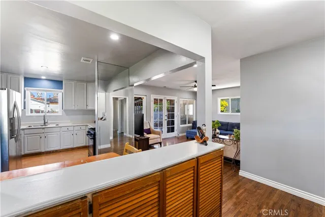 a kitchen with stainless steel appliances sink refrigerator and microwave