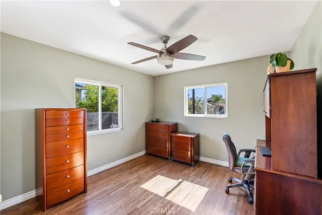 a view of a workspace with furniture and a window