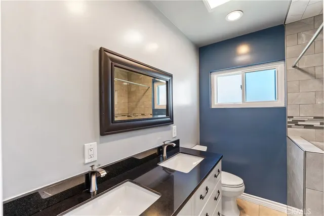 a bathroom with a toilet sink and mirror