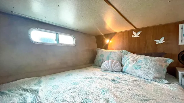 a large bed sitting in a bedroom next to a window