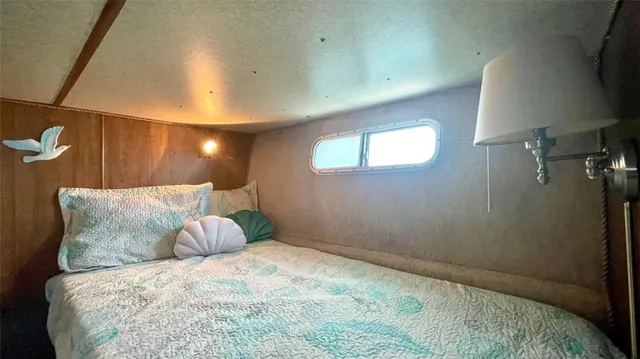 a large bedroom with a bed and lamp with window