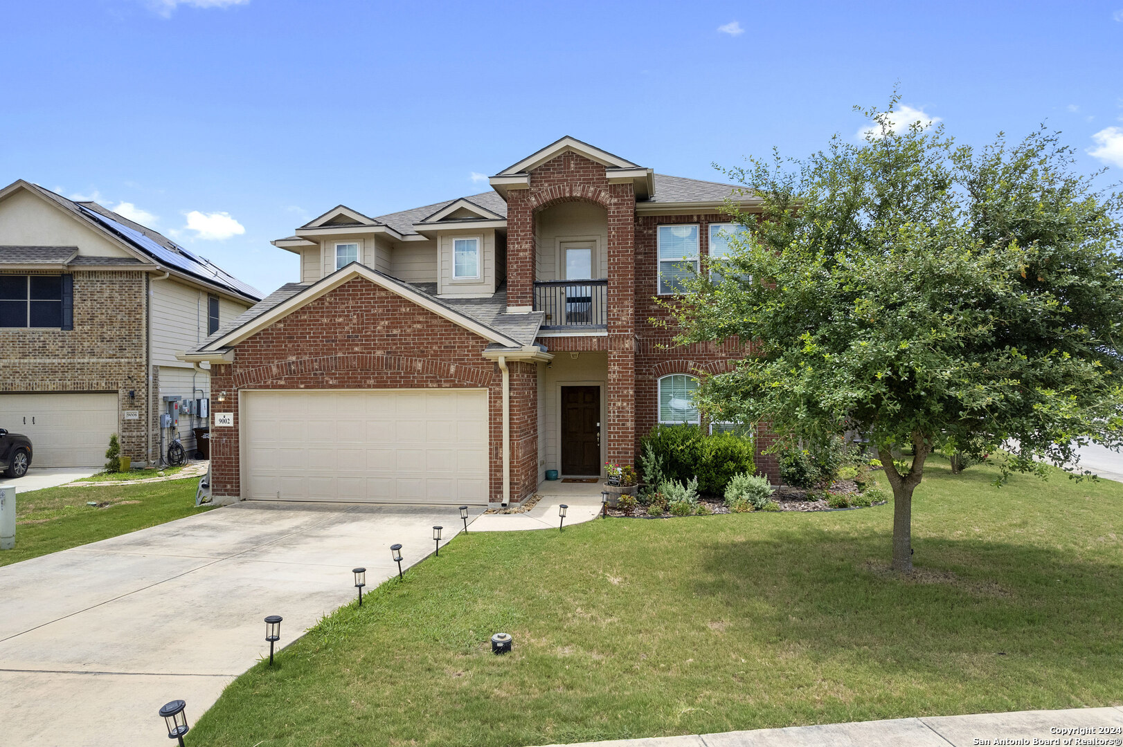 9002 Phoenix Park Converse, TX 78109 - Photo 1 of 1 a front view of a house with a yard and garage