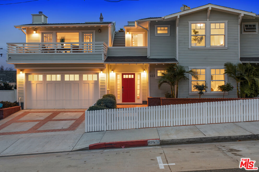 a view of a brick house with large windows