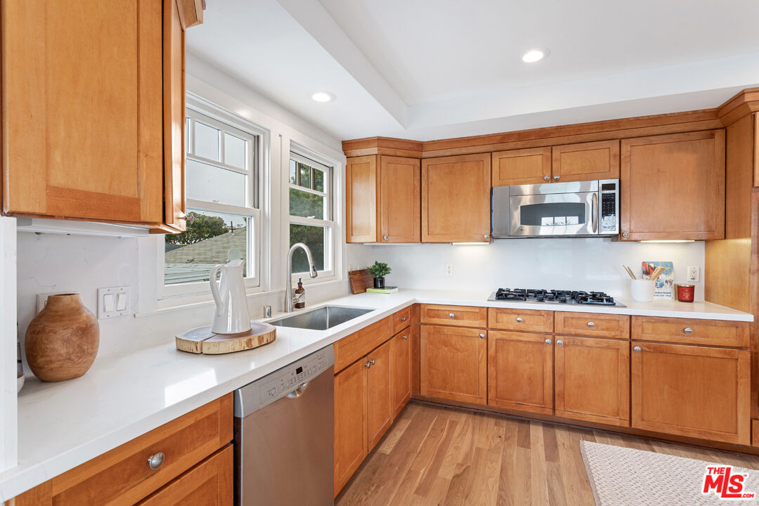 625 Diamond Street Redondo Beach, CA 90277 - Photo 12 of 42 a kitchen with stainless steel appliances granite countertop a sink a stove and cabinets