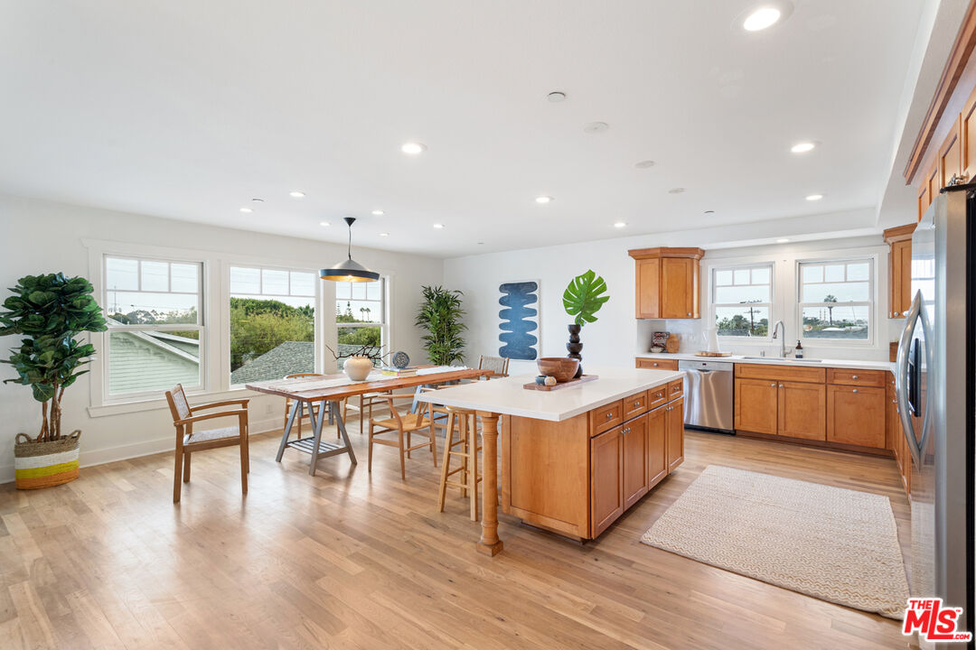 625 Diamond Street Redondo Beach, CA 90277 - Photo 14 of 42 a kitchen with stainless steel appliances granite countertop a table and chairs
