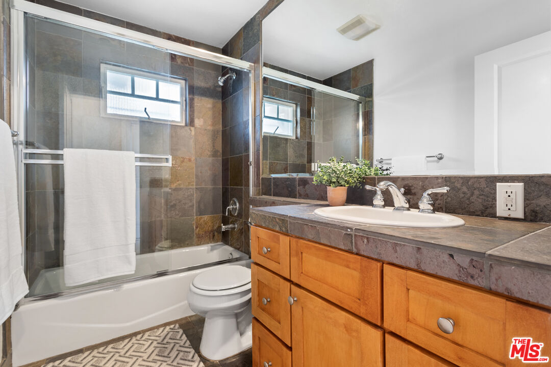 625 Diamond Street Redondo Beach, CA 90277 - Photo 21 of 42 a bathroom with a granite countertop sink toilet and shower
