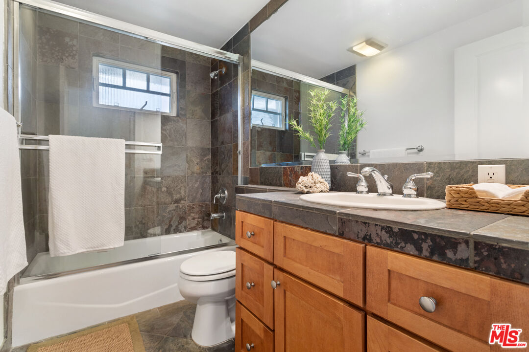 625 Diamond Street Redondo Beach, CA 90277 - Photo 30 of 42 a bathroom with a granite countertop sink toilet a mirror and shower