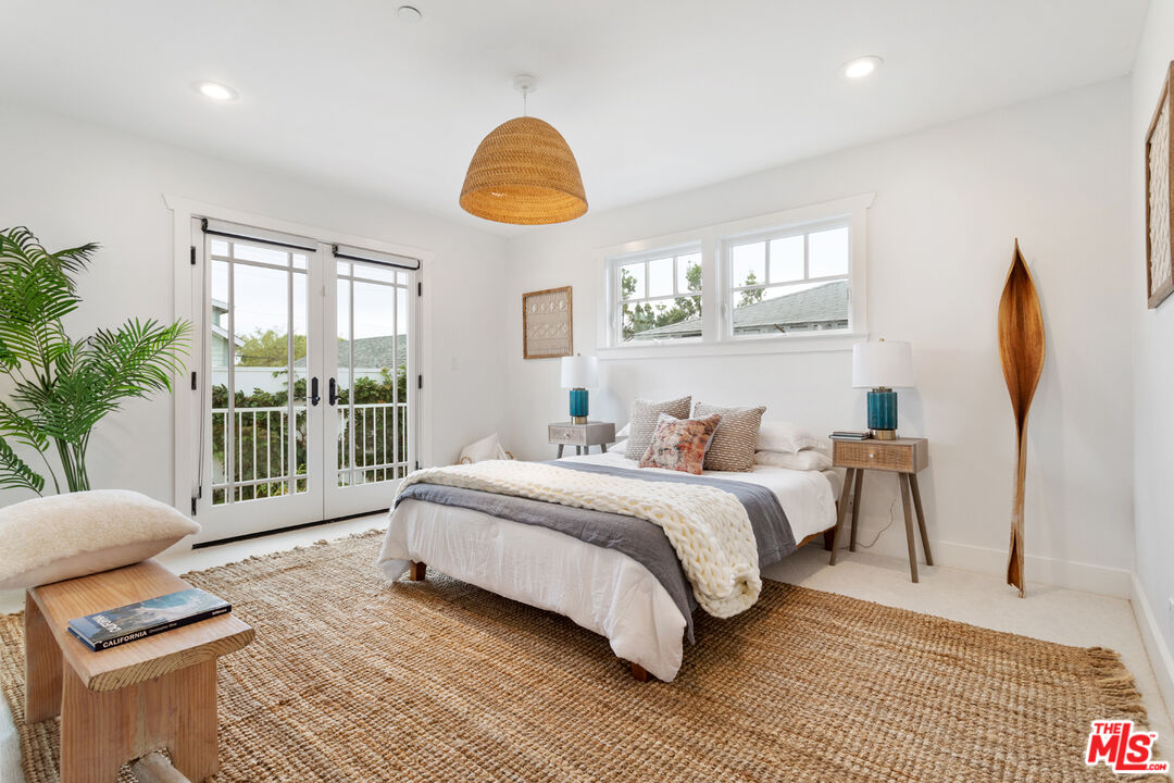 625 Diamond Street Redondo Beach, CA 90277 - Photo 31 of 42 a spacious bedroom with a bed a couch and a potted plant