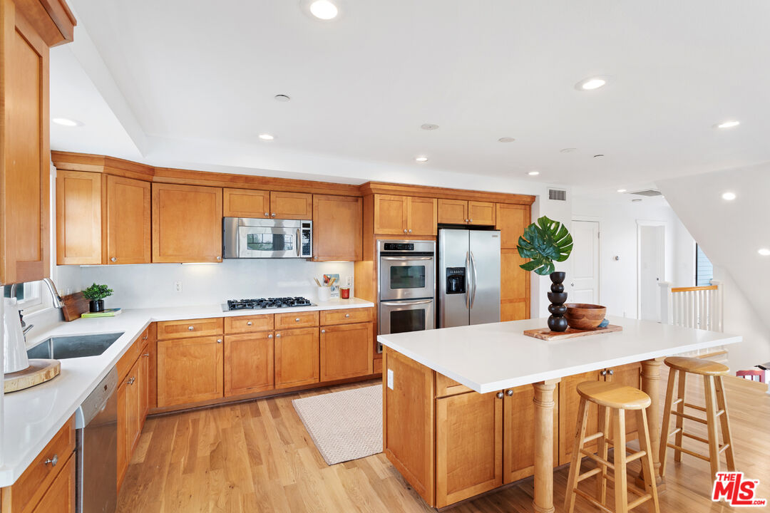 625 Diamond Street Redondo Beach, CA 90277 - Photo 10 of 42 a kitchen with stainless steel appliances granite countertop a sink stove and refrigerator